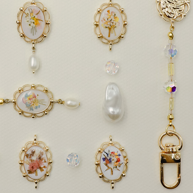 Collection of bag charm  and jewelry on a light background